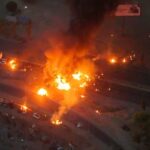 Updated Alt Text: Flames erupt from the Soku oil facility as an explosion sends fireballs into the sky at the NLNG site.