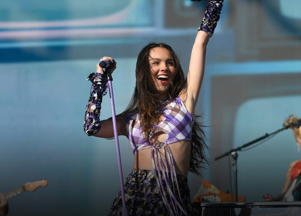Glastonbury Festival 2025: Your Full Guide to This Year’s Biggest Music Event | Epicstorian News Festivalgoers at Glastonbury 2025 wave flags under confetti at Worthy Farm's Pyramid Stage on opening day