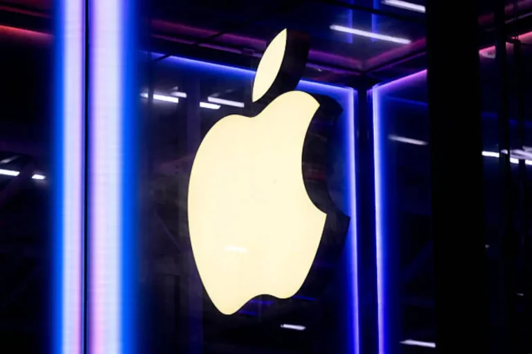 Apple logo shines at flagship Paris store, highlighting brand visibility despite ongoing global trade and AI challenges.