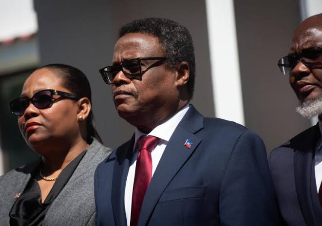 Haiti and Venezuela diplomats shake hands after restoring formal relations at an official meeting in Port-au-Prince.