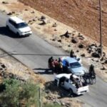 Syria Druze violence, fighters walk near destroyed military vehicles after Syria Druze violence in Sweida escalates severely.