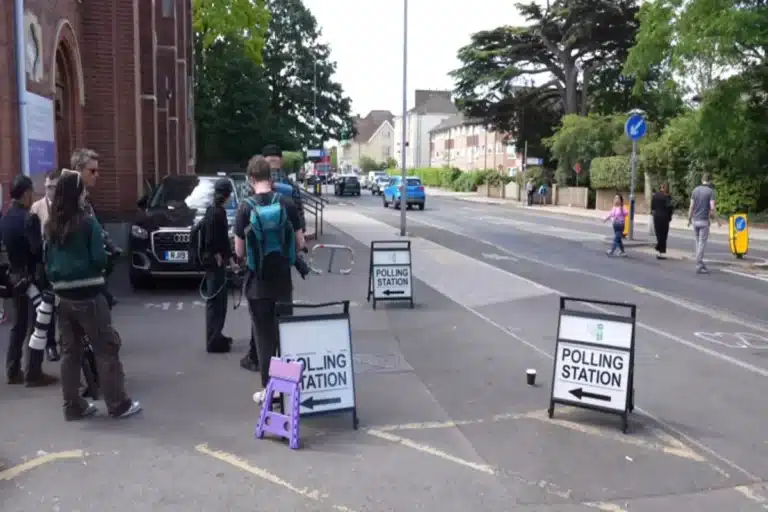 Young voters gather outside polling stations as UK government confirms voting age will lower to 16.
