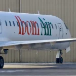 Ibom Air aircraft on runway with crew members boarding flight