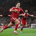 Liverpool players celebrate Premier League opening win over Bournemouth as police investigate alleged racism incident at Anfield.