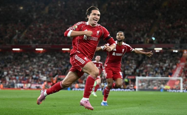 Liverpool players celebrate Premier League opening win over Bournemouth as police investigate alleged racism incident at Anfield.