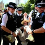 Police officers remove Palestine action protesters during the London ‘Lift The Ban’ pro-Palestine rally on August 9, 2025