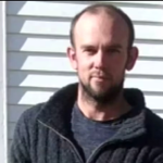 Police officers search remote New Zealand bushland after fugitive father shot dead and missing children recovered alive.
