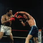 Joe Bugner stands in the boxing ring during his career, remembered for legendary bouts with Muhammad Ali and Frazier.
