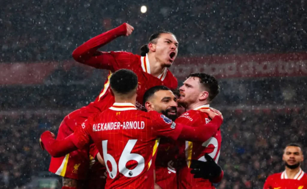 Darwin Núñez celebrates Liverpool victory at Anfield after scoring decisive stoppage-time goal against Manchester United.