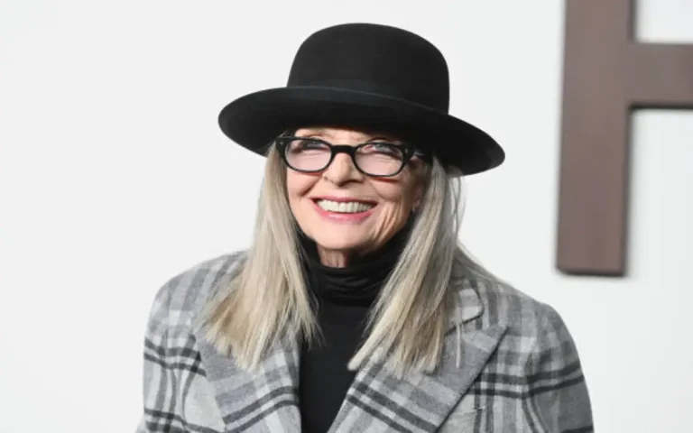 Diane Keaton smiling on red carpet, signature hat, elegant suit, late career public appearance