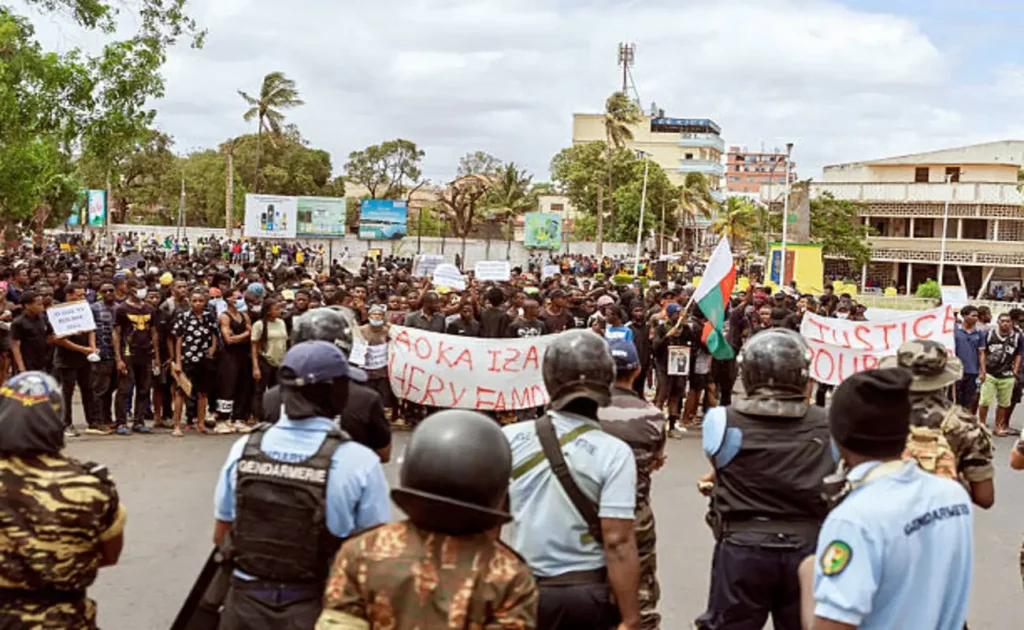 Madagascar in turmoil as protesters clash with police demanding President Andry Rajoelina resignation | Epicstorian News Protesters wave flags in Antananarivo as riot police stand guard during Madagascar protests demanding Rajoelina resignation.
