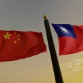 Chinese and Taiwanese flags displayed together, representing escalating tension over Taiwan PsyOps accusations by Beijing authorities.