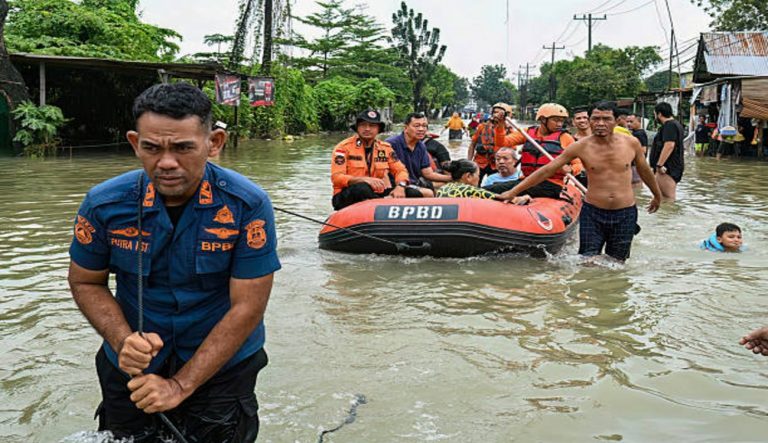 Rescuers evacuate elderly flood victim in North Sumatra as severe storms continue devastating communities across Asia.