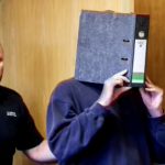 German nurse covers face while arriving at Aachen court before life sentence ruling for killing patients