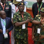 Nigerian soldiers stand guard at Defence Headquarters amid investigation into alleged coup attempt and internal military reforms.