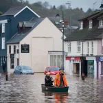 Rescue workers and emergency services respond to Storm Claudia flooding as roads and homes remain underwater