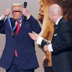 Donald Trump standing on stage at World Cup 2026 draw receiving FIFA Peace Prize at Kennedy Center