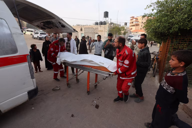 Palestinian medics transport body after Israeli airstrike in Khan Younis, Gaza, January 8, 2026