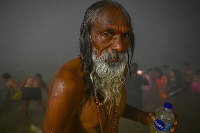 A Hindu devotee performs a holy dip at the Sangam during Mauni Amavasya celebrations in Prayagraj