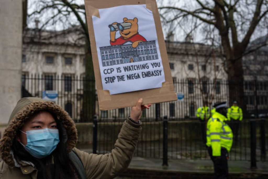 Protester demonstrates at Royal Mint site opposing China’s planned mega embassy near the Tower of London.