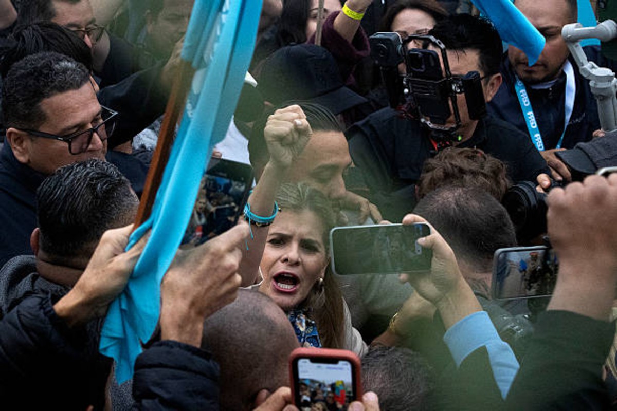 Supporters waving flags at a Costa Rica presidential election rally in San José