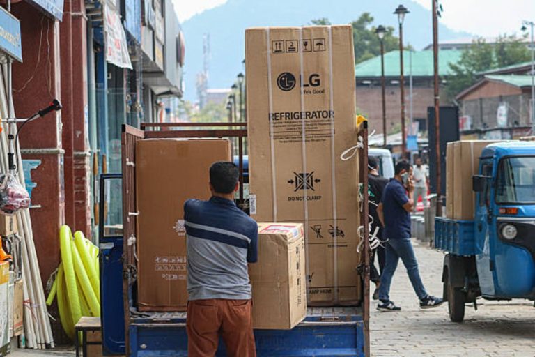 People buy goods at a market in Srinagar as Trump announces tariffs on Indian imports and penalties for Russian oil purchases