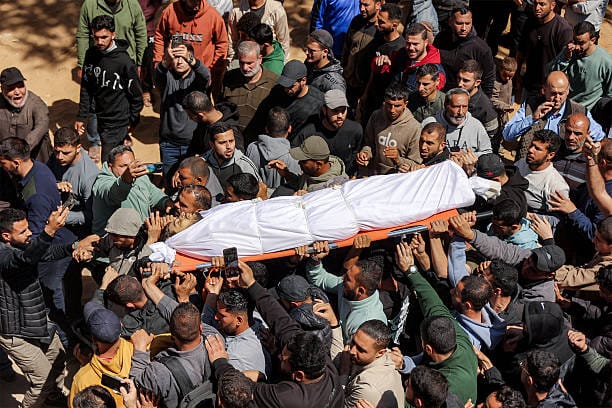 Funeral Held in Gaza for Son of Hamas Negotiator Killed in Israeli Airstrike as Cairo Talks Continue | Epicstorian News Mourners carry the body of Azzam Al-Hayya during funeral in Gaza City after he was killed in an Israeli airstrike.
