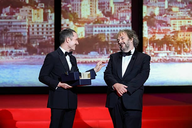 Peter Jackson receives Honorary Palme d’Or at Cannes opening ceremony | Epicstorian News Peter Jackson receiving Honorary Palme d’Or from Elijah Wood during Cannes Film Festival 2026 opening ceremony on stage